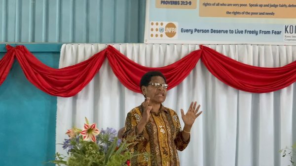 A speaker addresses the graduates. Catholic Diocese of Goroka, YC Hall, Goroka, Eastern Highlands. September 2026.