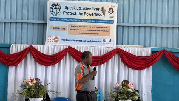 A speaker addresses the graduates. Catholic Diocese of Goroka, YC Hall, Goroka, Eastern Highlands. September 2026.