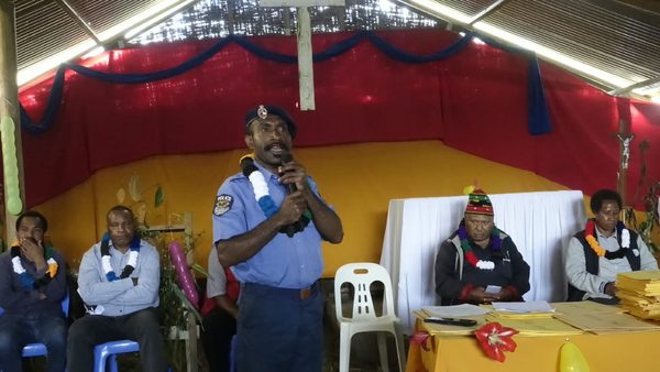 A police representative speaks at the graduation. Catholic Diocese of Mendi, Lower Mendi Parish Centre, Tepe, Southern Highlands. September 2026.